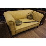 A 19th century-style Chesterfield two-seater sofa with fabric upholstery, adjustable arm rest,