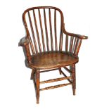 A 19th century elm country kitchen chair with hooped spindle support, carved arm rests, dished seat,