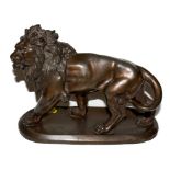 A bronzed spelter model of standing lion on oblong plinth marked 'Coinchon', 16cm high