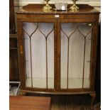 An early 20th century mahogany display cabinet with astragal doors, adjustable glass shelves, raised