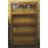 A 1920s Globe Wernicke Limited light oak bookcase with four up and over glazed doors with