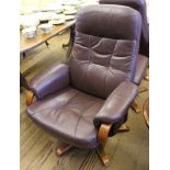 A 'Chairman' Mobel Team (Sweden) leather swivel reclining chair and foot stool with stained hardwood