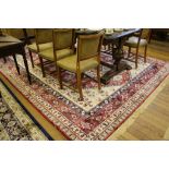 A red ground cashmere Aztec-design drawing room carpet, 380cm x 280cm