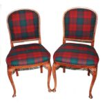 A pair of 19th century-style stained hardwood dining chairs with fabric upholstered support and