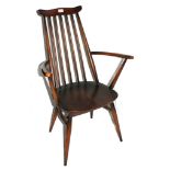 A vintage Ercol kitchen chair with shaped top rail, spindle supports, arched arm rest, dished