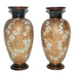 A pair of early 19th century Royal Doulton baluster-shaped vases with flared rims on circular bases,