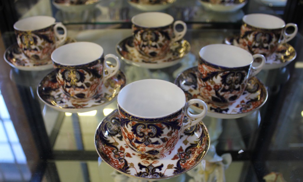 A set of six 19th century Royal Crown Derby blue and ochre floral and foliate decorated cups and