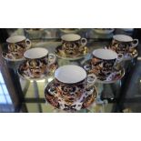 A set of six 19th century Royal Crown Derby blue and ochre floral and foliate decorated cups and