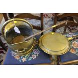 A 19th century brass coal scuttle, a circular brass bed warmer with turned handle and one copper