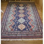 A multicoloured floor rug with isometric designs with short fringe, 225 cm x 155 cm