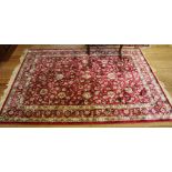 A red ground all over design floral drawing room rug, 200cm x 140cm