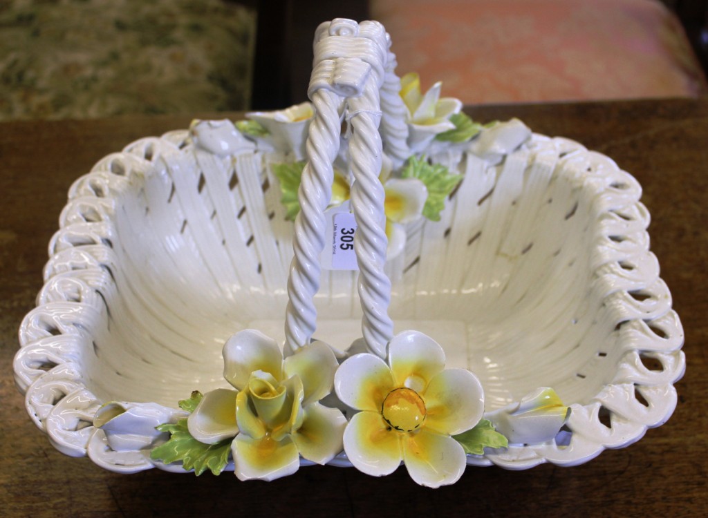 A Capodimonte fruit or flower ceramic basket with weaved design, rope twist handle and floral