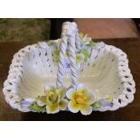 A Capodimonte fruit or flower ceramic basket with weaved design, rope twist handle and floral