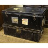 Two mid 20th century black painted metal travel trunks with brass fittings