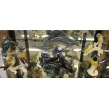 A Lladro figurine of two dolphins riding a wave, a similar Poole Pottery figurine of a dolphin and