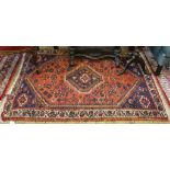 A Middle Eastern-style multicoloured wool floor rug 165 cm x 110 cm