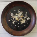 An early 20th century Japanese lacquered charger with mother of pearl avian and foliate decoration