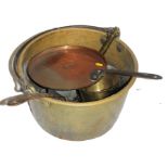 A 19th century circular brass bastable with swing handle, together with other pots and pans