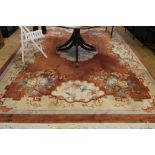 A contemporary Oriental-style wool drawing room rug with multicoloured floral and foliate depictions