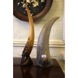 A carved hardwood bovine-shaped horn and an African hardwood carved figurine of a tribesman