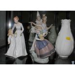 A Lladro figurine of a clown with ballerina, 26cm high, a Lladro figurine of a girl with flowers,