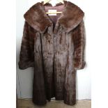 A mid 20th century lady's full length fur coat retailed by Heelas of Reading