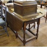 A 19th century oak gate leg action table with twin drop leaves, raised on turned legs and