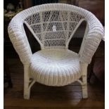 A white painted wicker conservatory chair with hoop back support and circular seat