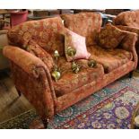 A Victorian-style mahogany framed three seater fabric upholstered sofa with removable cushions,