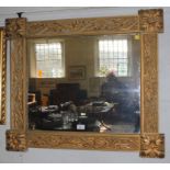 A 19th century Continental-style oblong wall mirror with profusely carved frame depicting floral and