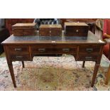 A Victorian rosewood writing table with tooled leather inset, all over inlay, shaped top with four