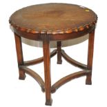 An early 20th century circular oak centre or occasional table with pie crust rim, square fluted legs