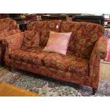 A Victorian-style mahogany framed three seater fabric upholstered sofa with removable cushions,