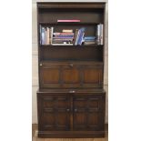 A mid 20th century oak dresser with carved frieze, three plate shelves, fold down section with two