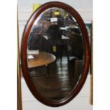 An Edwardian mahogany and cross banded oval wall mirror, fitted for hanging, 67cm x 43cm