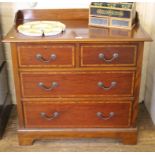 An Edwardian mahogany chest of two small and two graduated drawers with shaped top with tray