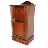 An Edwardian mahogany bedside locker with domed tray back, single panelled door with brass drop