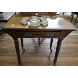 A late Victorian side table with shaped top, one drawer under, with carved brass drop handles,