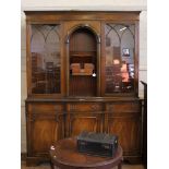 *A Georgian-style mahogany bookcase with dentil frieze, twin astragal doors, shelved interior over