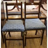 A pair of late 19th century oak framed occasional chairs with leather back support, swab cushions,