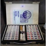 A mid 20th century mahjong set in leather case with instructions