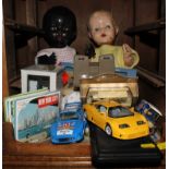 A selection of vintage dolls and model cars, etc
