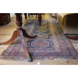 A mid 20th century Persian hand knotted wool floor rug with multicoloured isometric designs, 250cm x