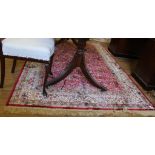 A Middle Eastern-style red ground drawing room rug with a double border, multicoloured isometric