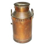 An early 20th century copper milk churn with twin handles and lid with 'Novac 65' embossed label,