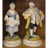 A pair of late 19th century / early 20th century Continental-style figurines of a lady and gent in