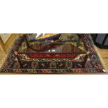 A Middle Eastern-style hand knotted wool prayer rug with multicoloured isometric designs with long