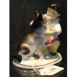 A ceramic figurine of a young boy with husky dog on an oblong base, Made in the USSR, 13cm high £