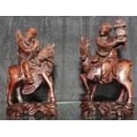 A pair of early 20th century carved wooden figurines of wise men on horses on stylized bases, 15cm