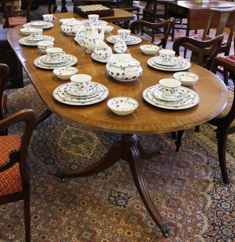 *A Regency-style mahogany and cross banded 'D' end extending dining table with ebony string inlay